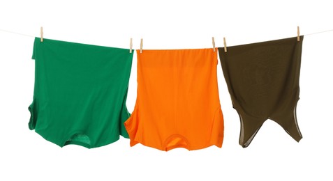 Photo of Different clothes drying on laundry line against white background