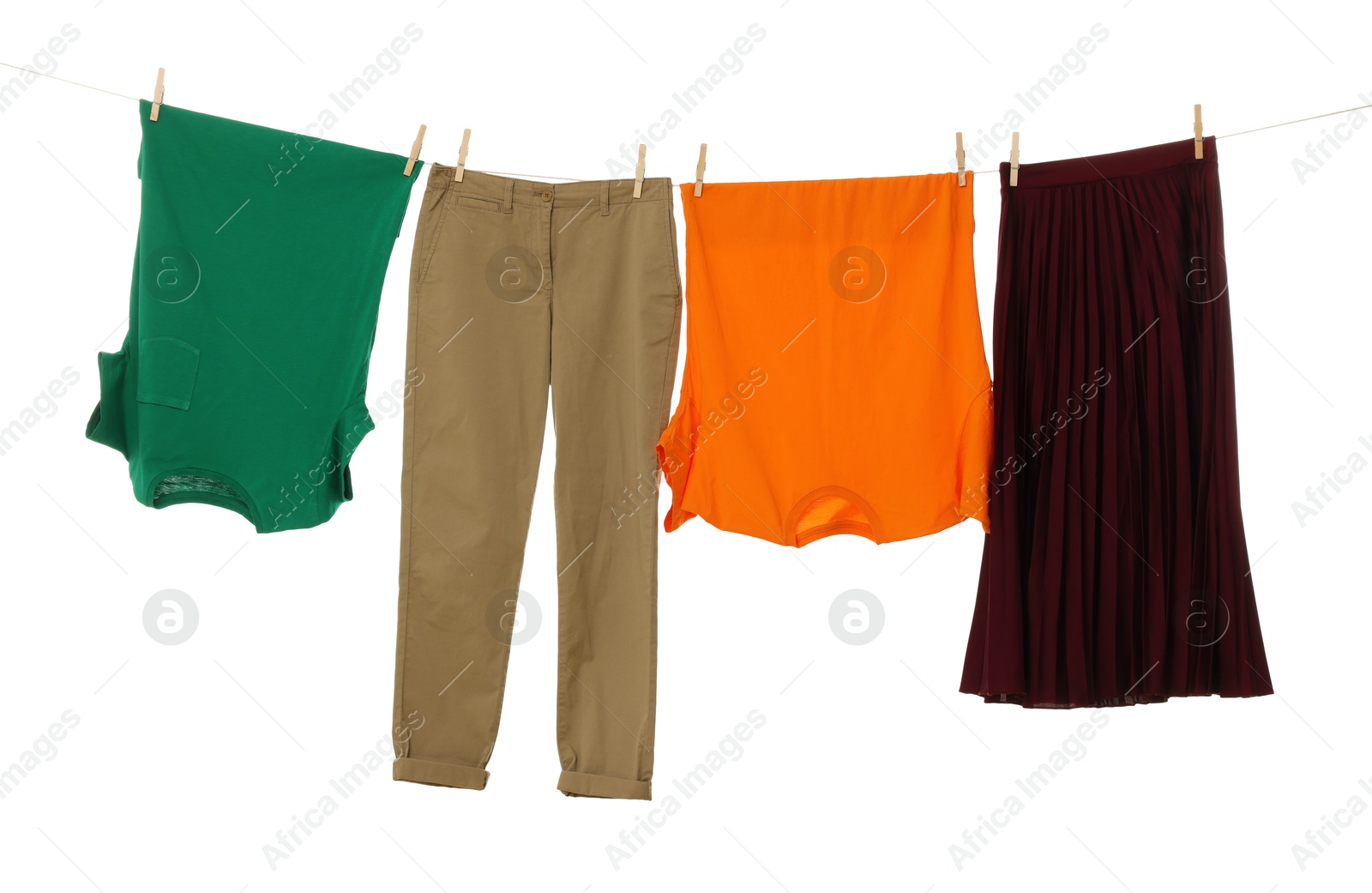 Photo of Different clothes drying on laundry line against white background