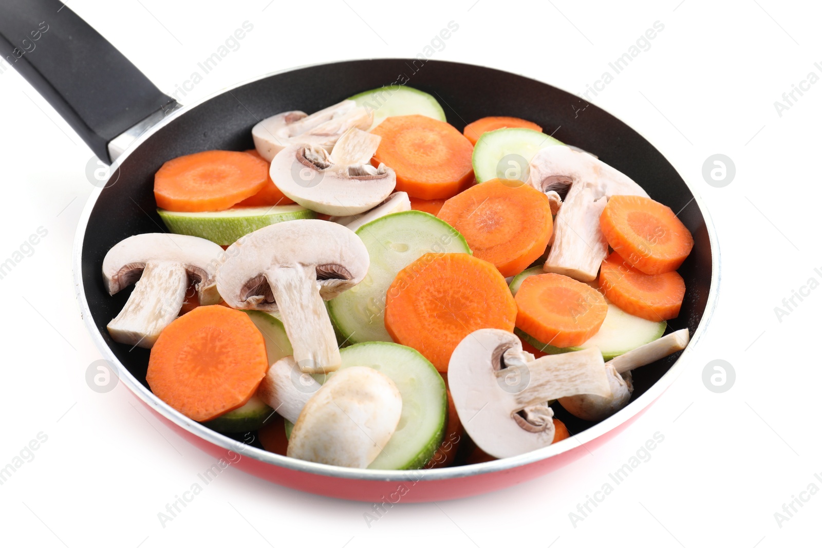 Photo of Frying pan with fresh vegetables and mushrooms isolated on white