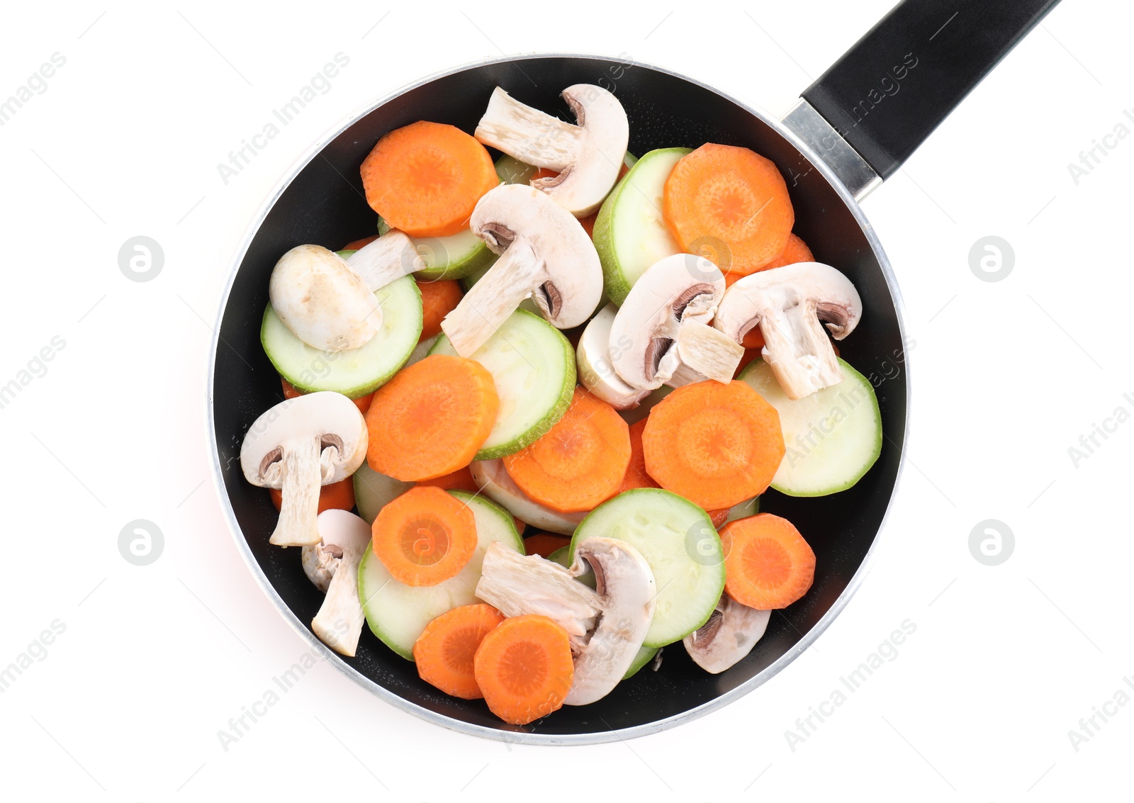 Photo of Frying pan with fresh vegetables and mushrooms isolated on white, top view