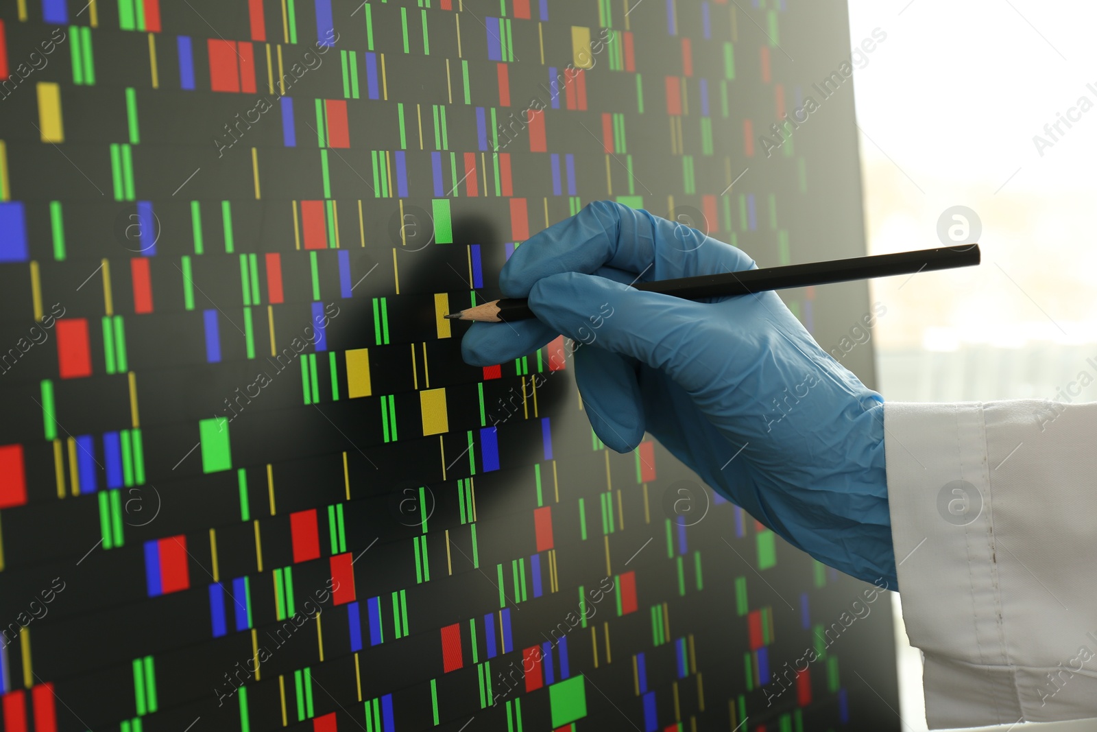 Photo of Scientist analyzing DNA data in laboratory, closeup