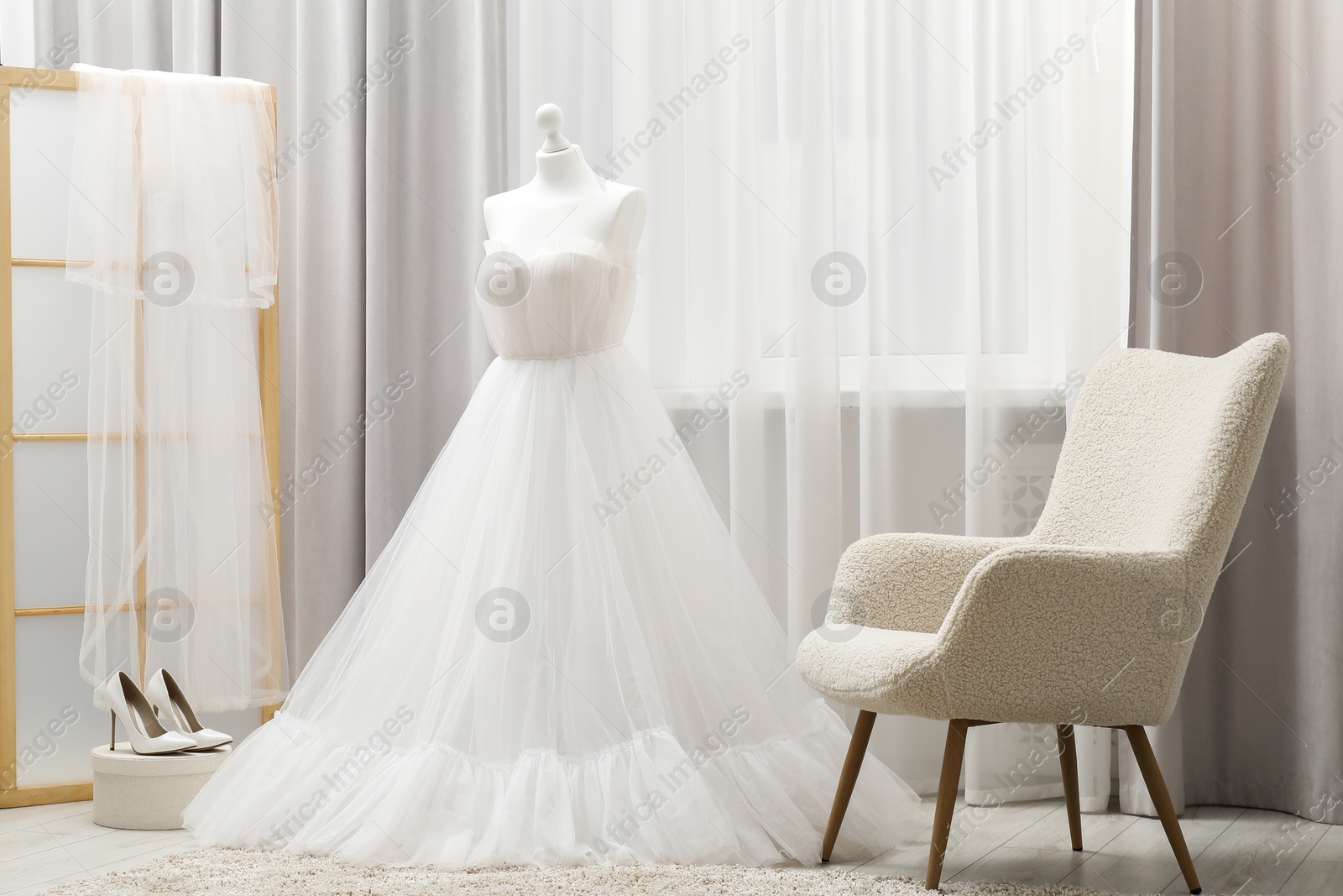 Photo of Beautiful wedding dress on mannequin and shoes in boutique