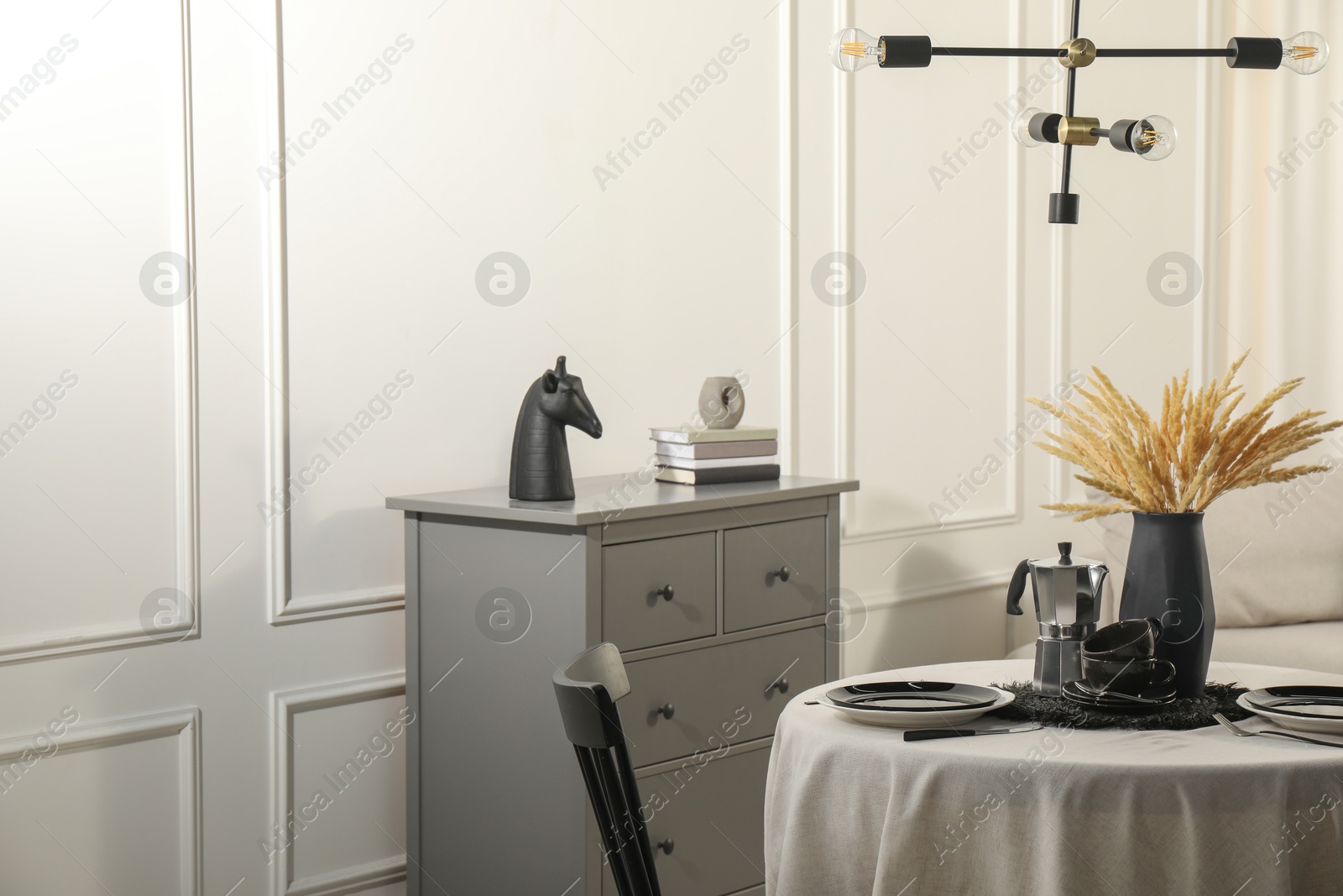 Photo of Stylish table setting with black dishware in dining room