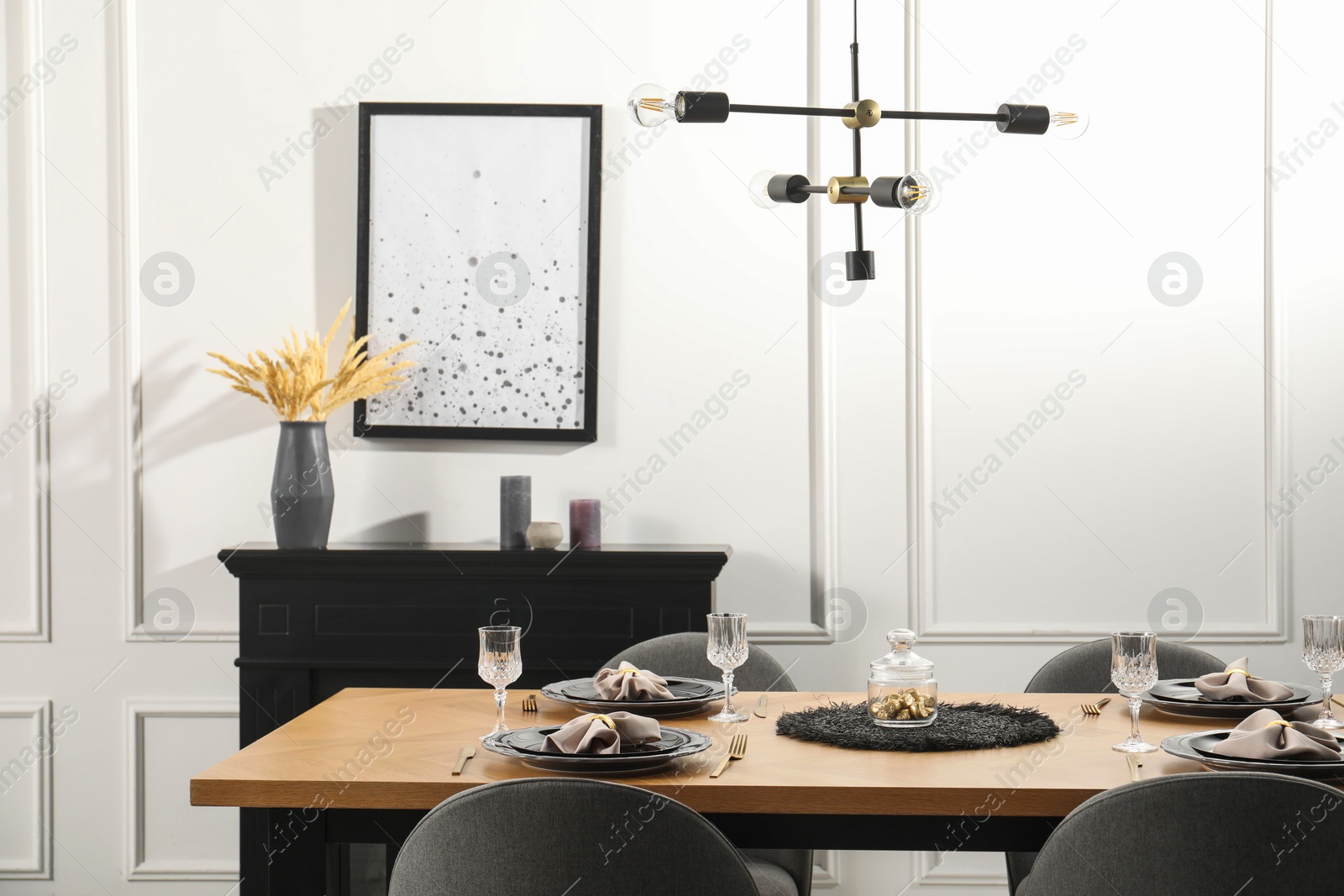 Photo of Stylish table setting with black dishware in dining room