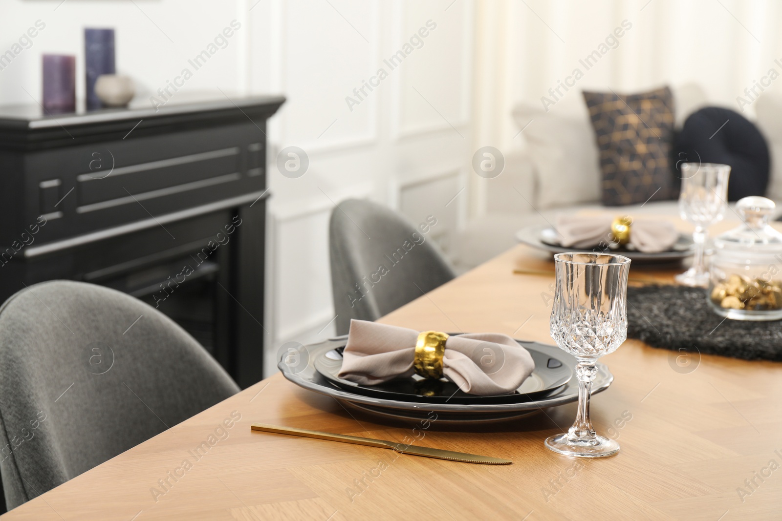 Photo of Stylish table setting with black dishware in dining room