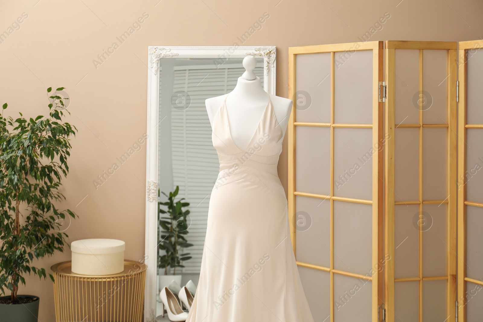 Photo of Beautiful wedding dress on mannequin in boutique