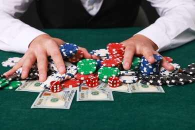 Photo of Professional croupier accepting bets at gambling table, closeup