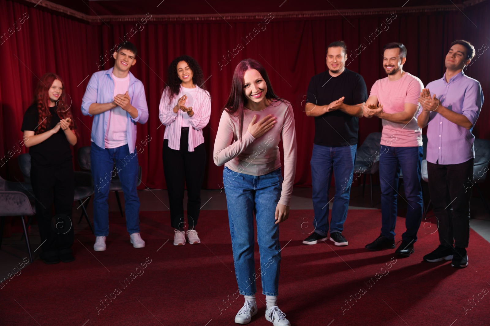 Photo of Professional actors bowing on stage in theatre