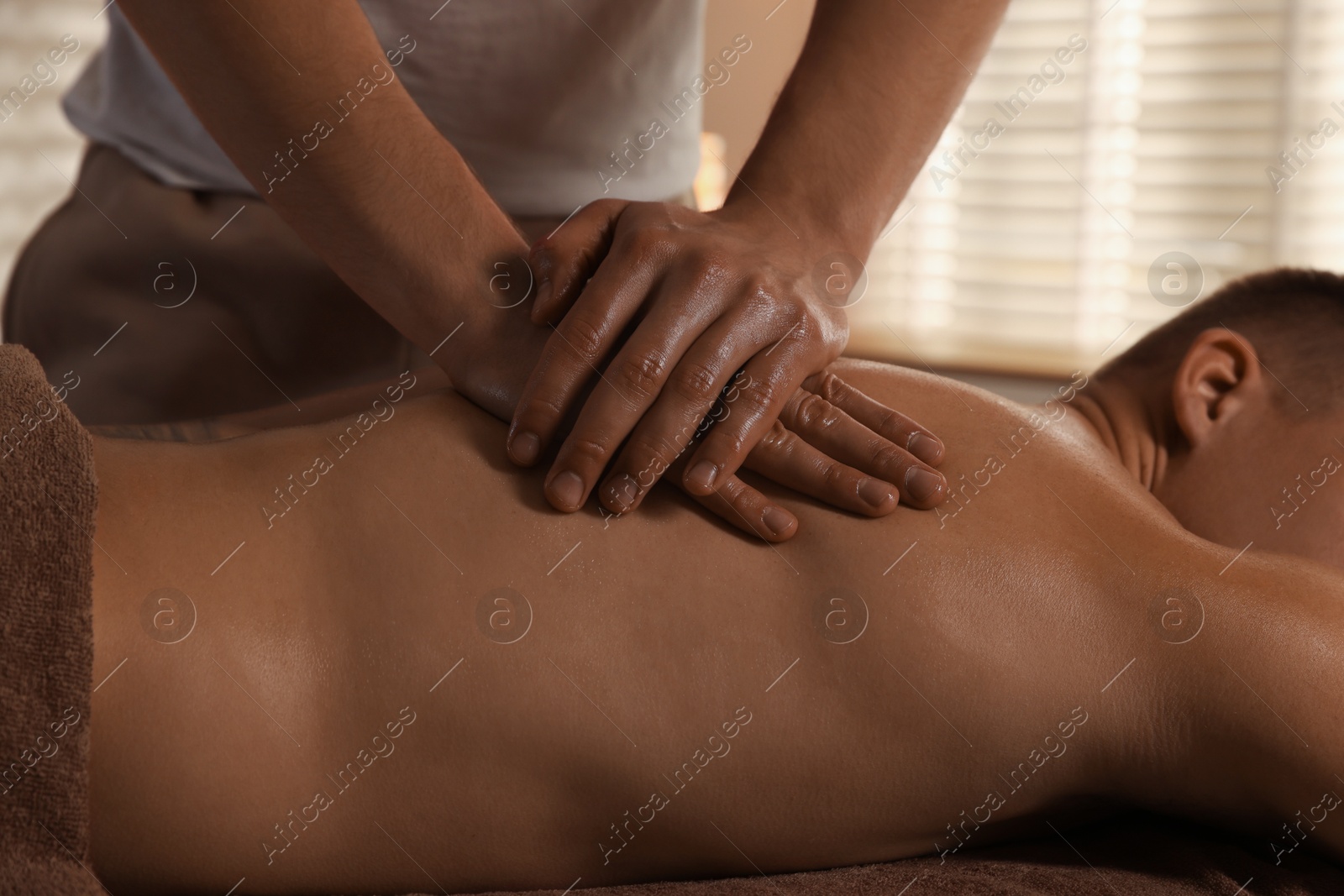 Photo of Massage therapist working with patient in clinic, closeup