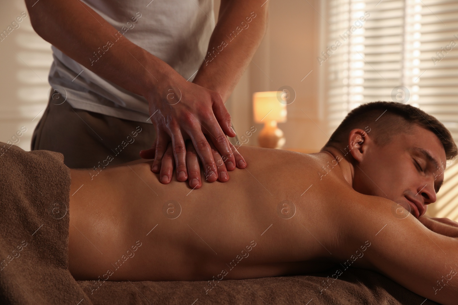 Photo of Massage therapist working with patient in clinic, closeup