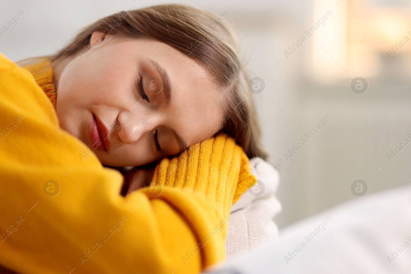 Photo of Charming young woman on sofa at home. Autumn atmosphere