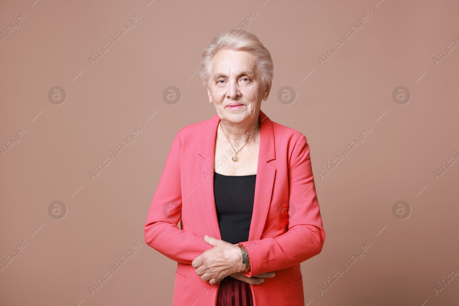 Photo of Portrait of senior woman on color background