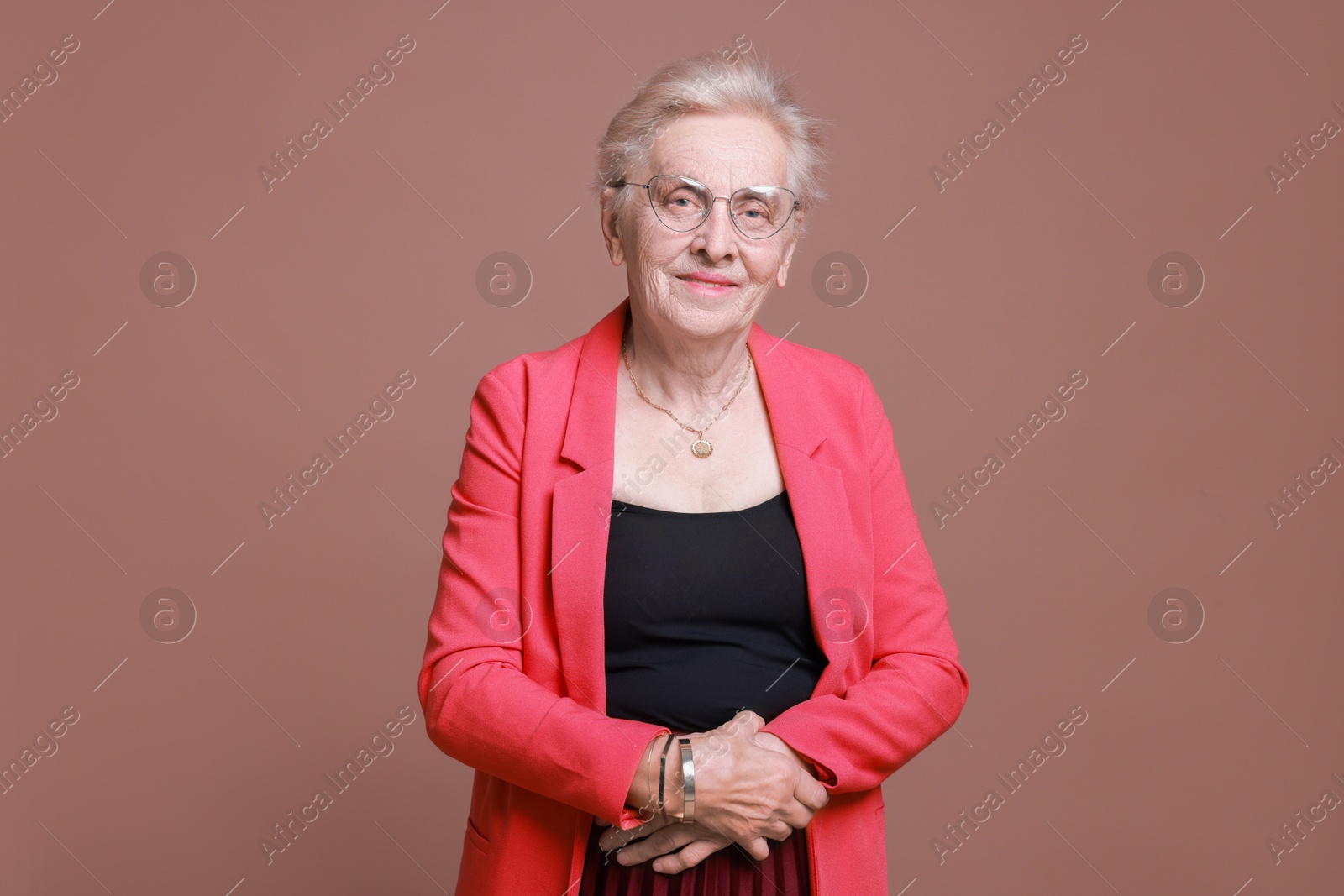 Photo of Portrait of senior woman on color background