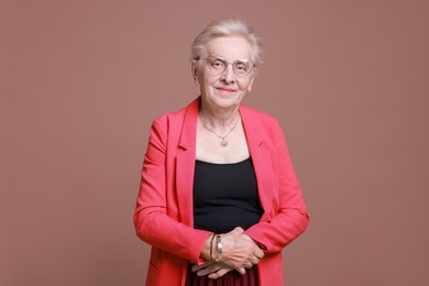 Photo of Portrait of senior woman on color background