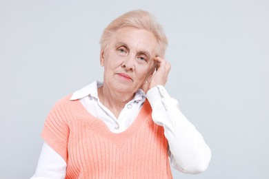 Photo of Portrait of senior woman on light background