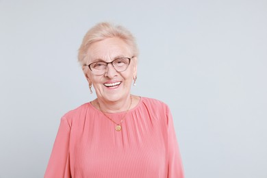 Photo of Portrait of senior woman on light background. Space for text