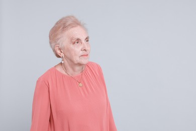 Photo of Portrait of senior woman on light background. Space for text