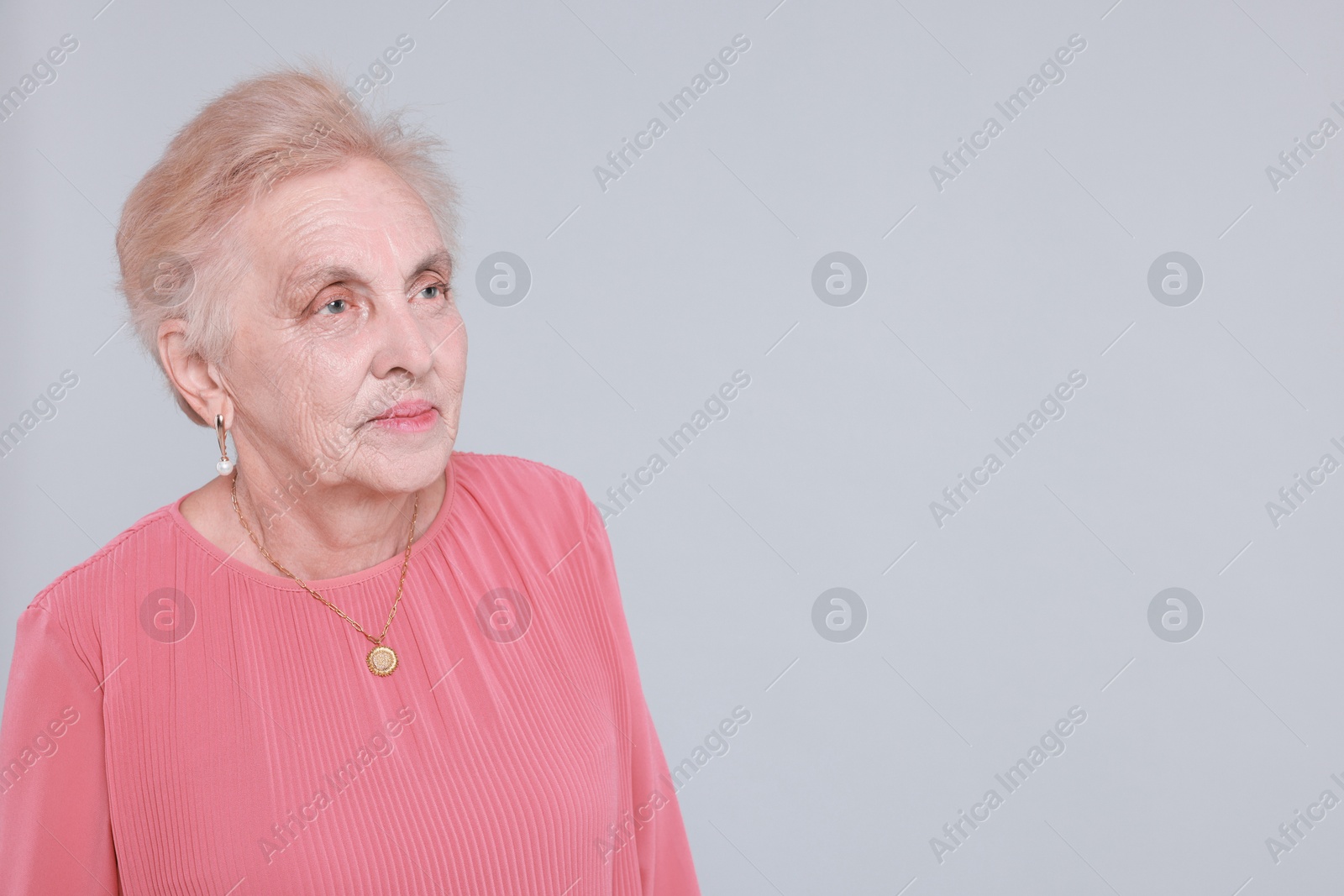 Photo of Portrait of senior woman on light background. Space for text