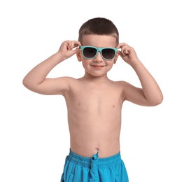 Photo of Cute little boy in beachwear on white background