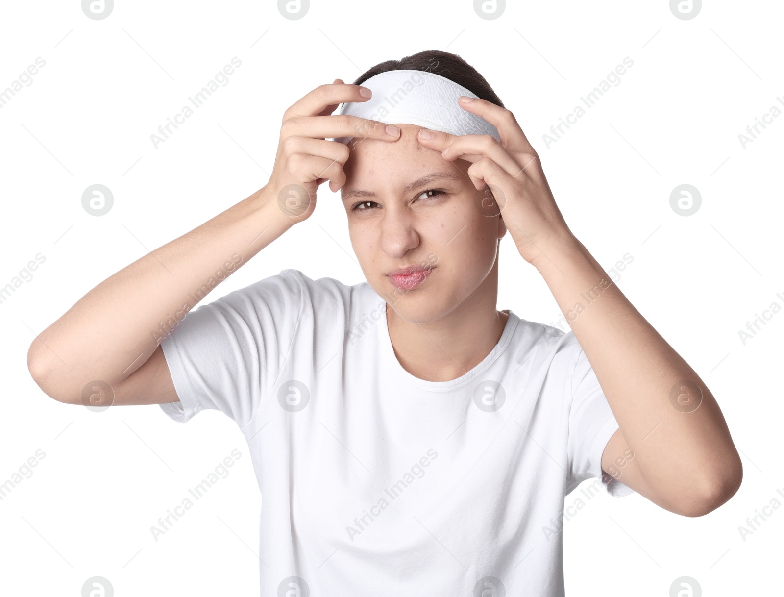 Photo of Teenage girl popping pimple on her face against white background. Acne problem