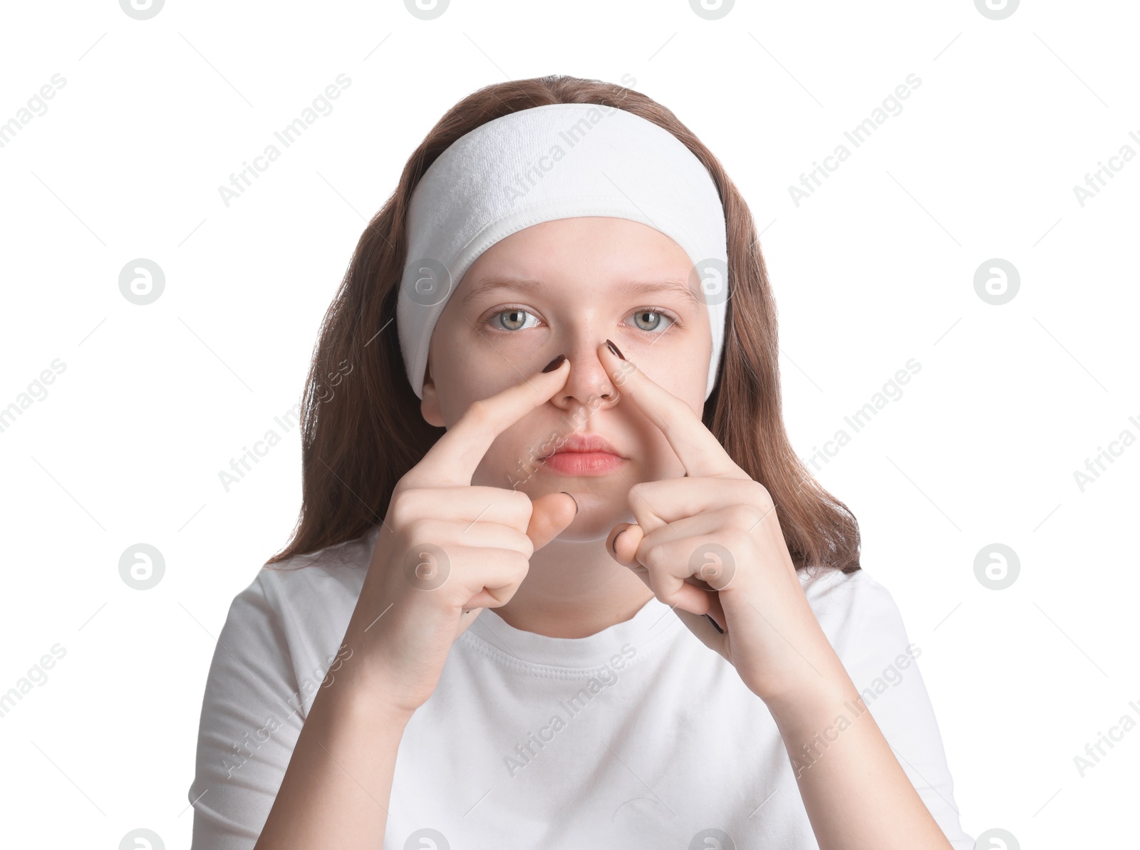 Photo of Teenage girl popping pimple on her face against white background. Acne problem