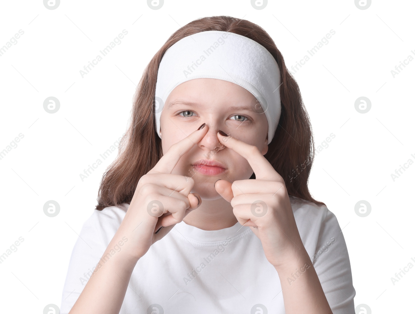 Photo of Teenage girl popping pimple on her face against white background. Acne problem