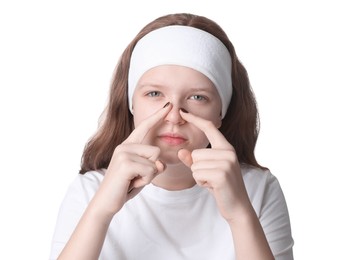 Teenage girl popping pimple on her face against white background. Acne problem