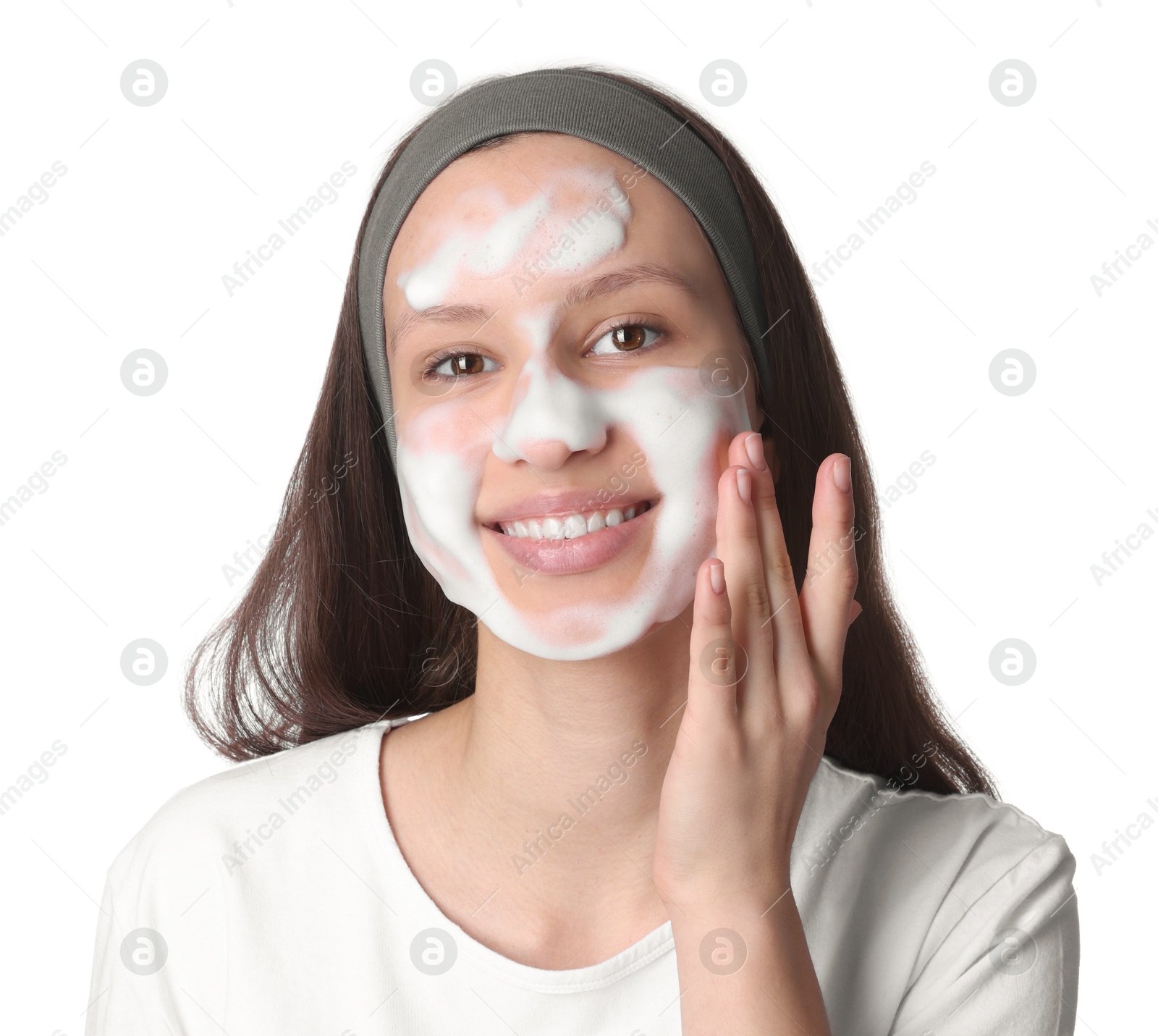 Photo of Teenage girl washing her face with cleanser on white background. Cosmetic product