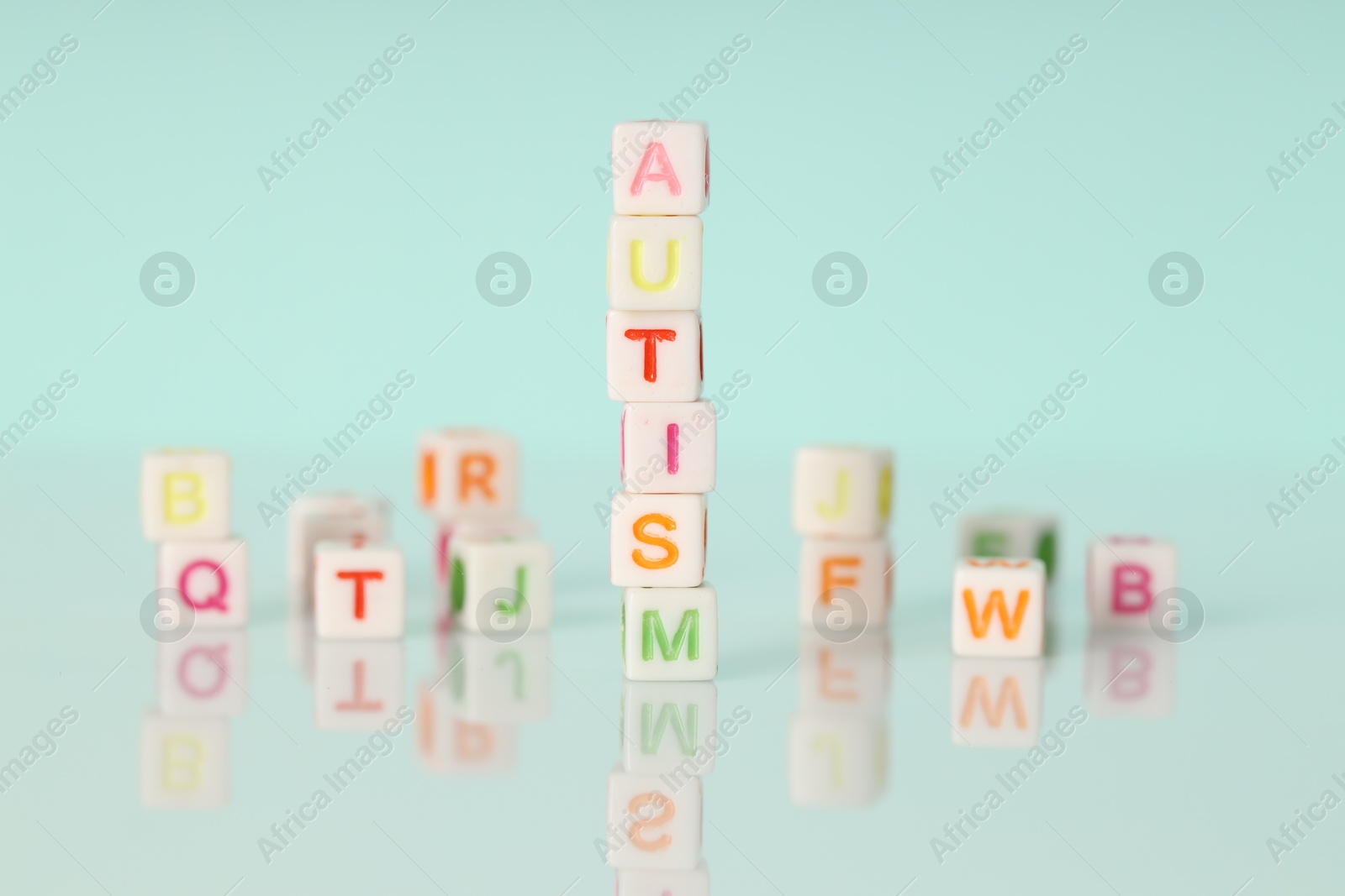 Photo of Word Autism made of colorful cubes on light background