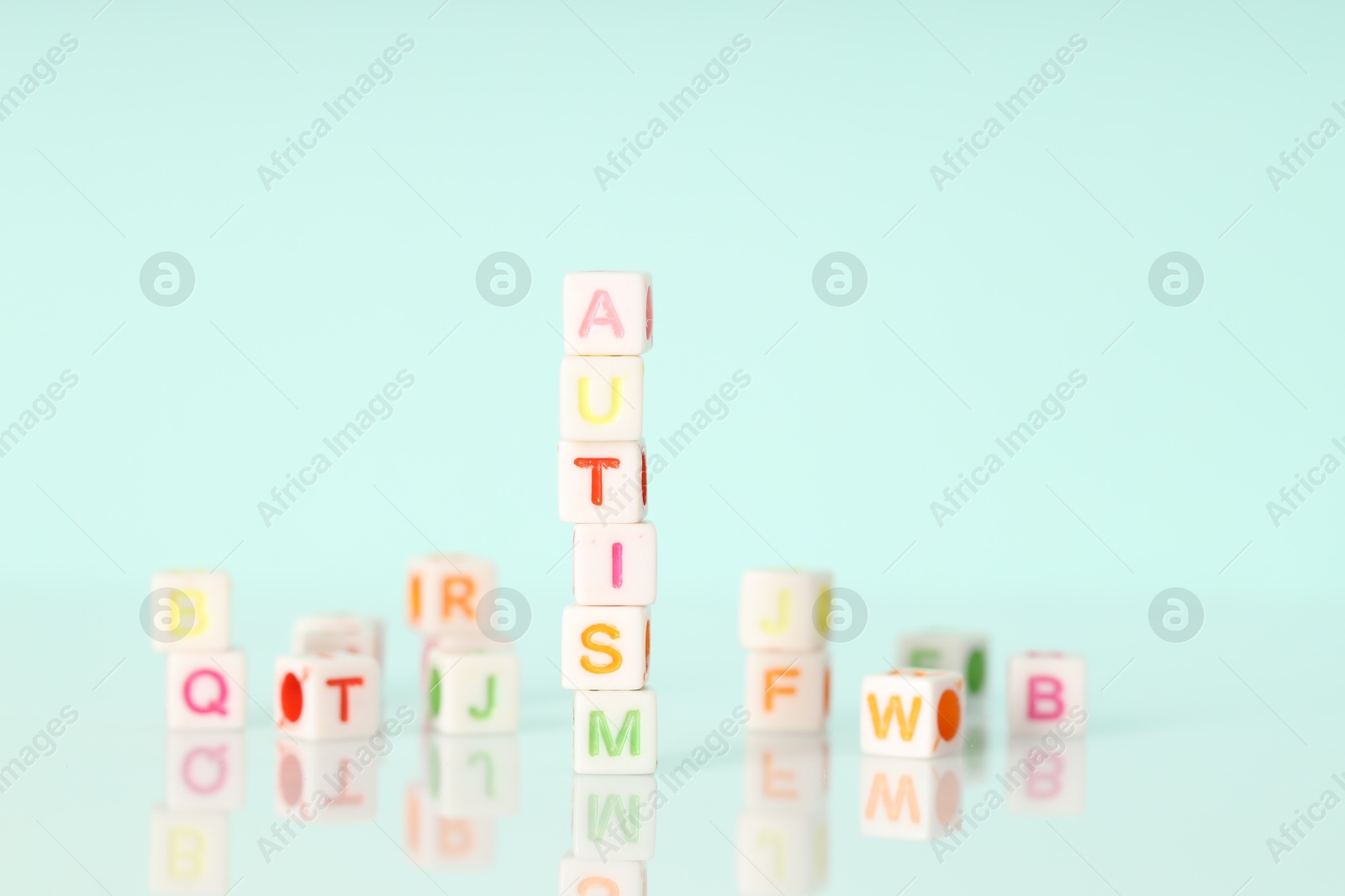 Photo of Word Autism made of colorful cubes on light background