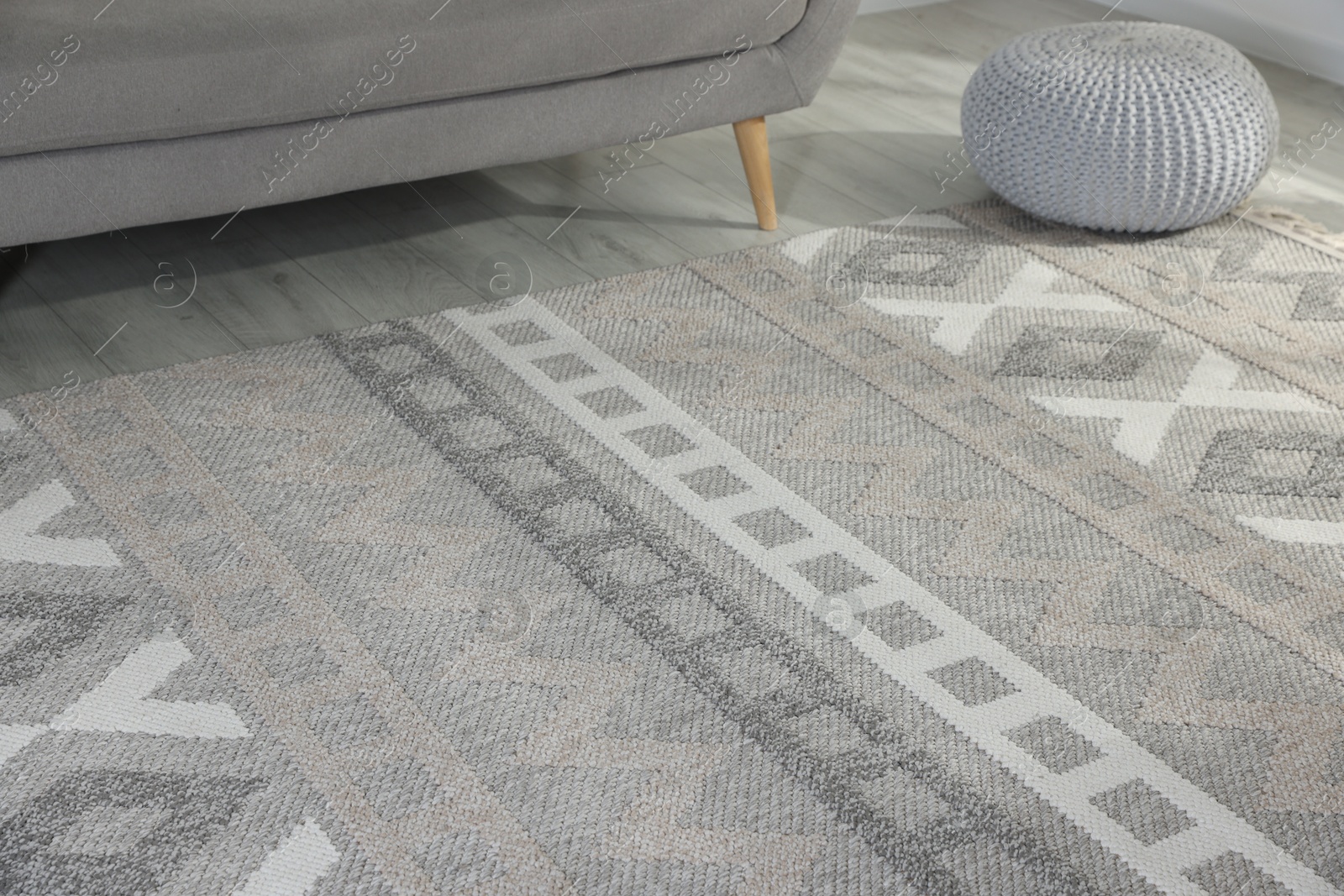Photo of Stylish soft rug with pattern on floor in living room
