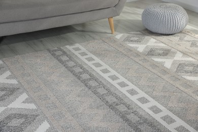 Photo of Stylish soft rug with pattern on floor in living room
