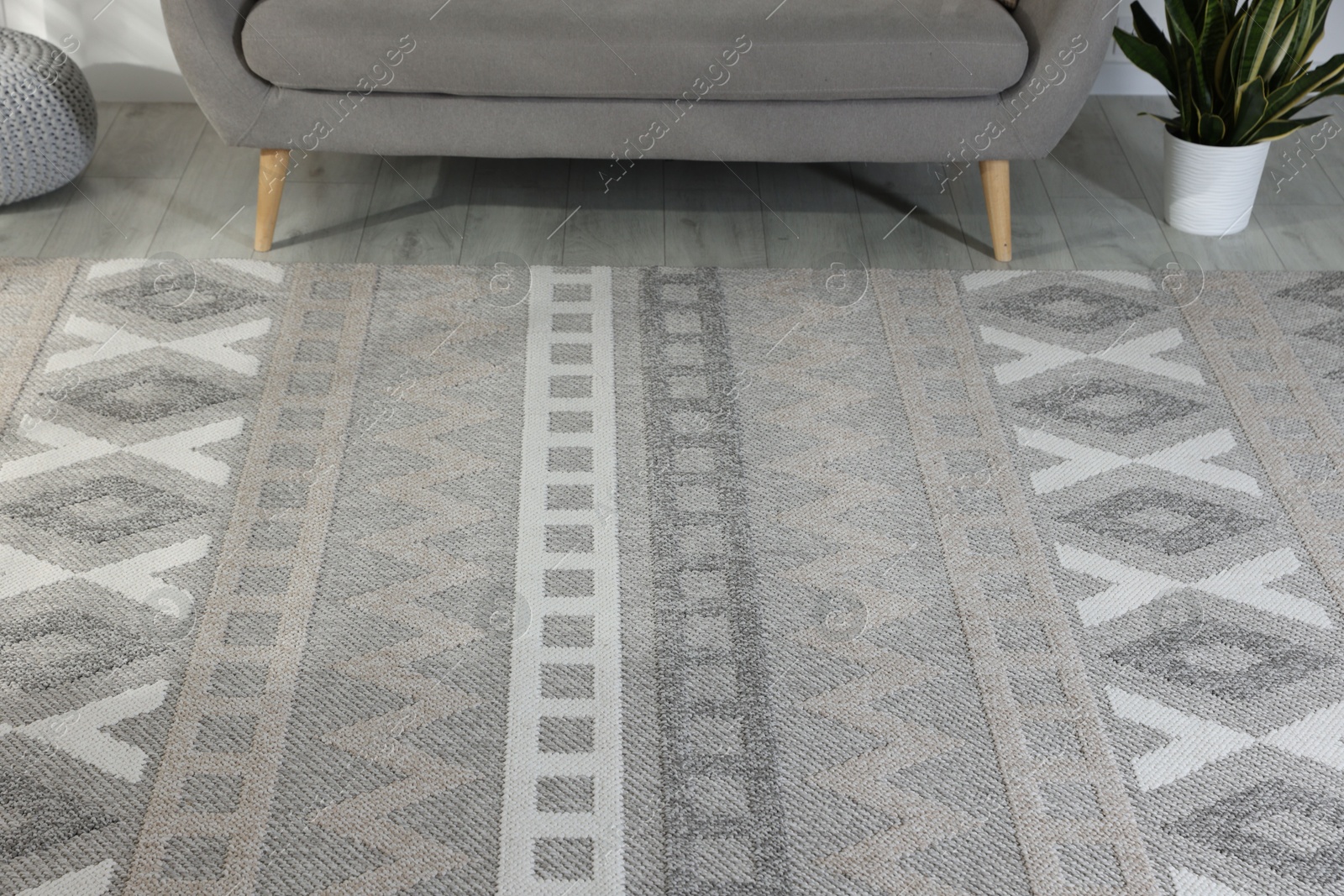 Photo of Stylish soft rug with pattern on floor in living room