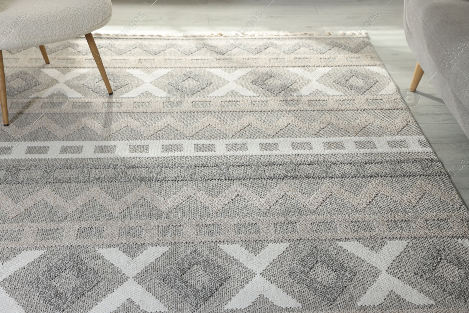 Photo of Stylish soft rug with pattern on floor in living room