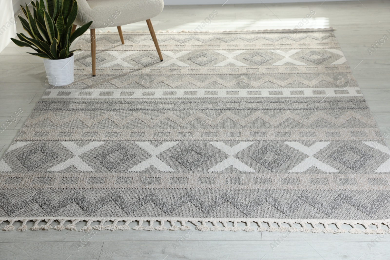 Stylish soft rug with pattern on floor in living room Photo of Stylish soft rug with pattern on floor in living room