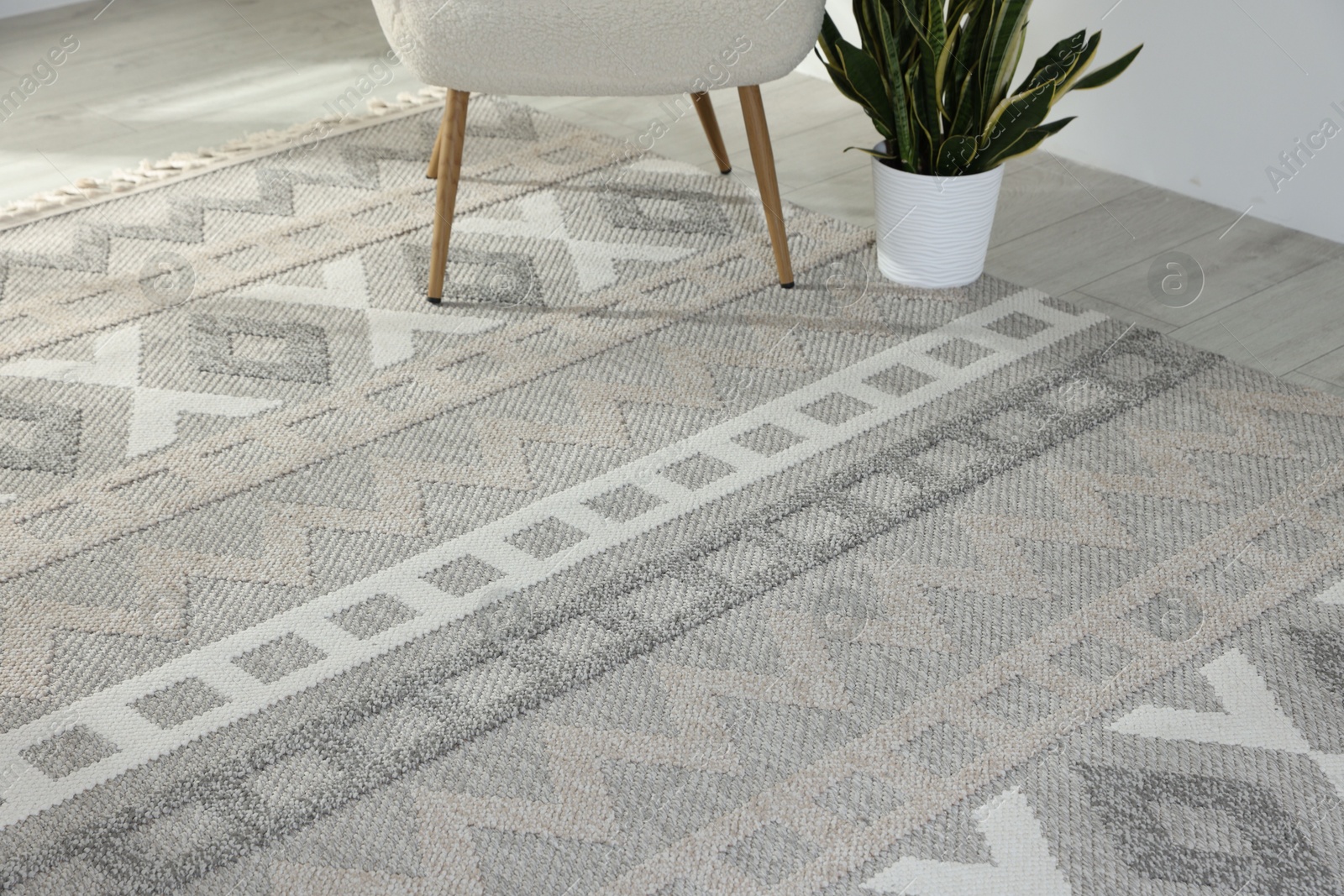 Stylish soft rug with pattern on floor in living room Photo of Stylish soft rug with pattern on floor in living room