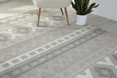 Photo of Stylish soft rug with pattern on floor in living room