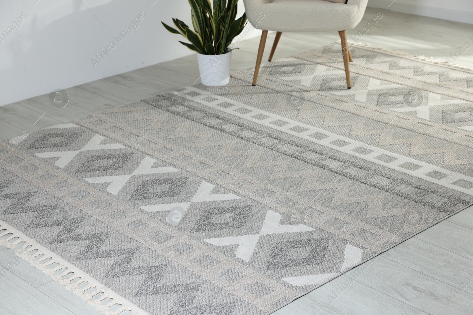 Stylish soft rug with pattern on floor in living room Photo of Stylish soft rug with pattern on floor in living room
