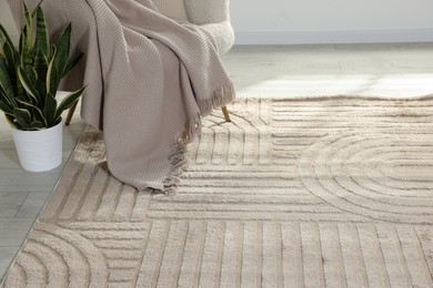 Photo of Stylish soft rug with pattern on floor in living room