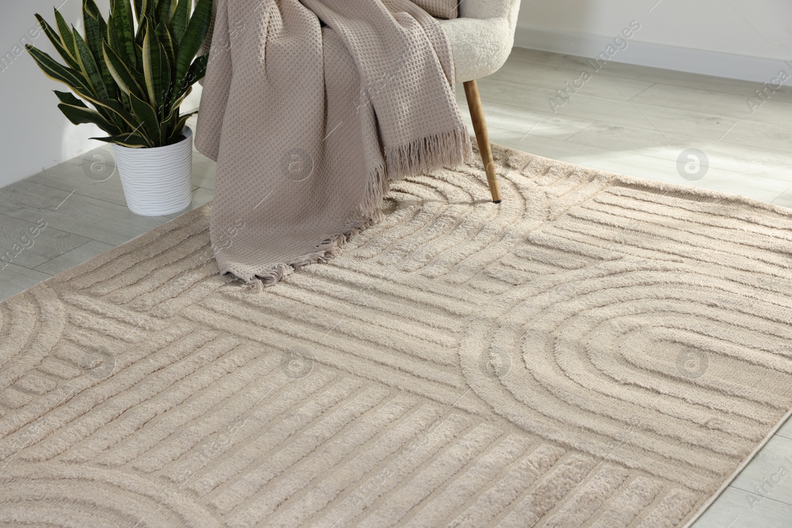 Photo of Stylish soft rug with pattern on floor in living room