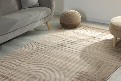 Photo of Stylish soft rug with pattern on floor in living room