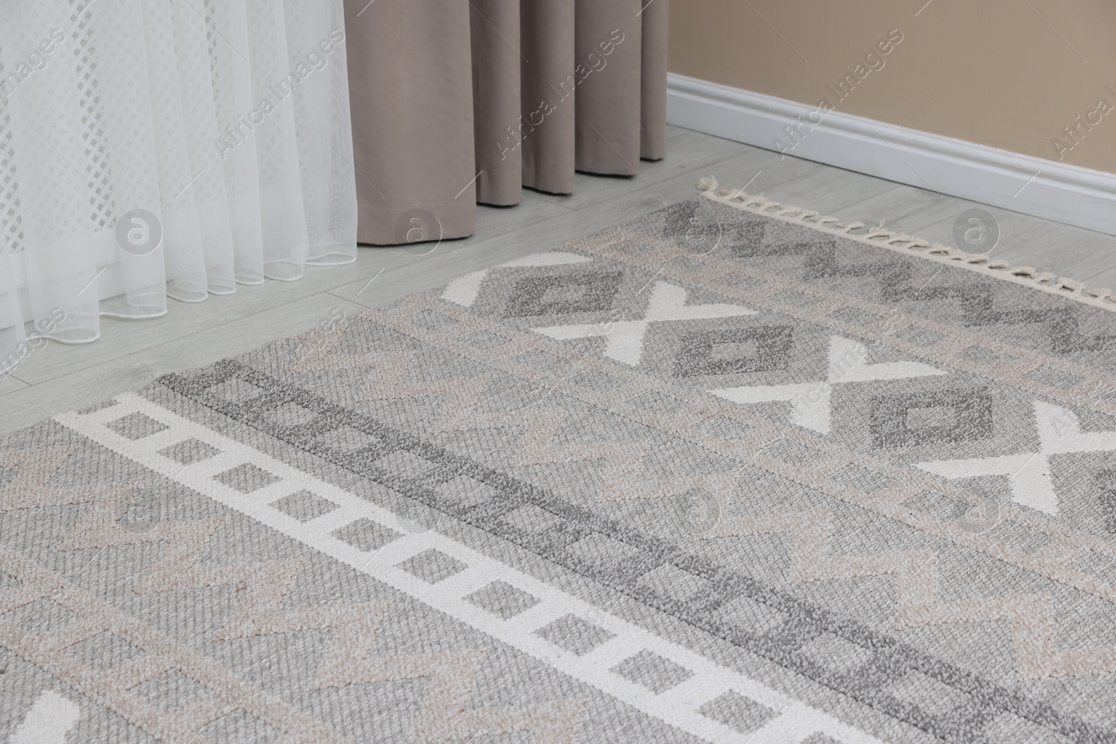 Photo of Stylish soft rug with pattern on floor indoors