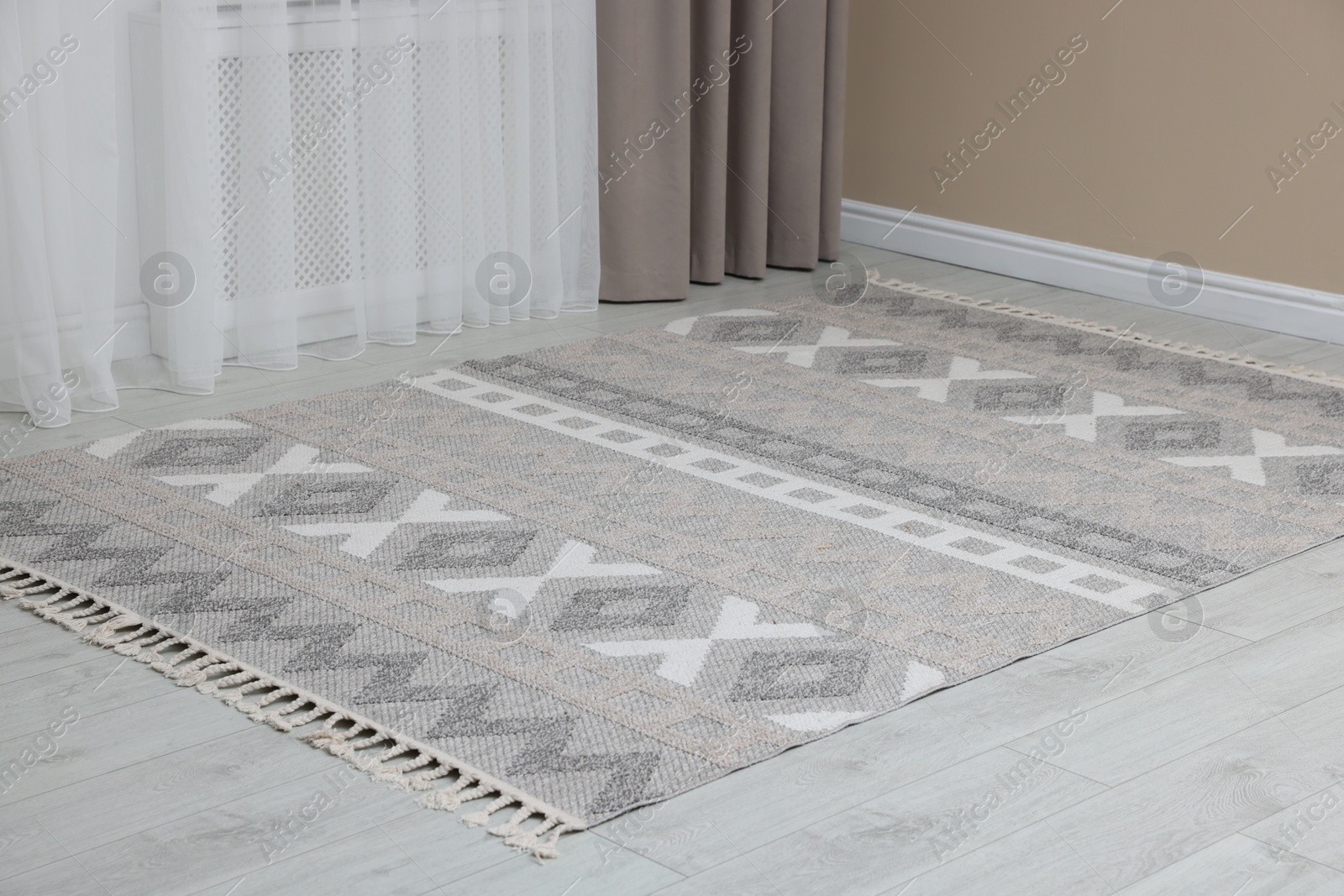 Photo of Stylish soft rug with pattern on floor indoors
