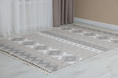 Photo of Stylish soft rug with pattern on floor indoors