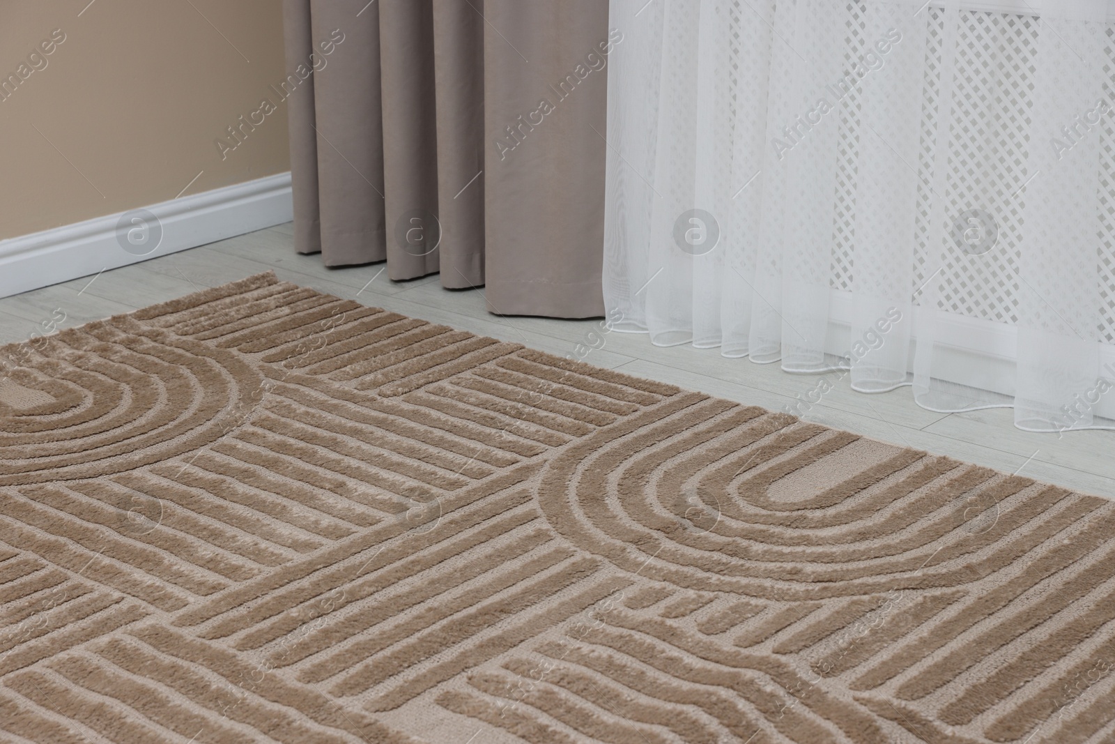 Stylish soft rug with pattern on floor indoors Photo of Stylish soft rug with pattern on floor indoors