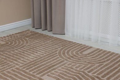 Photo of Stylish soft rug with pattern on floor indoors