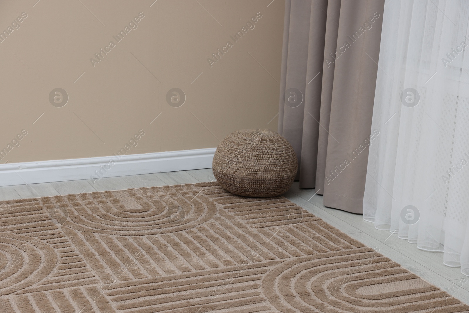 Stylish soft rug with pattern on floor indoors Photo of Stylish soft rug with pattern on floor indoors