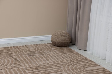 Photo of Stylish soft rug with pattern on floor indoors