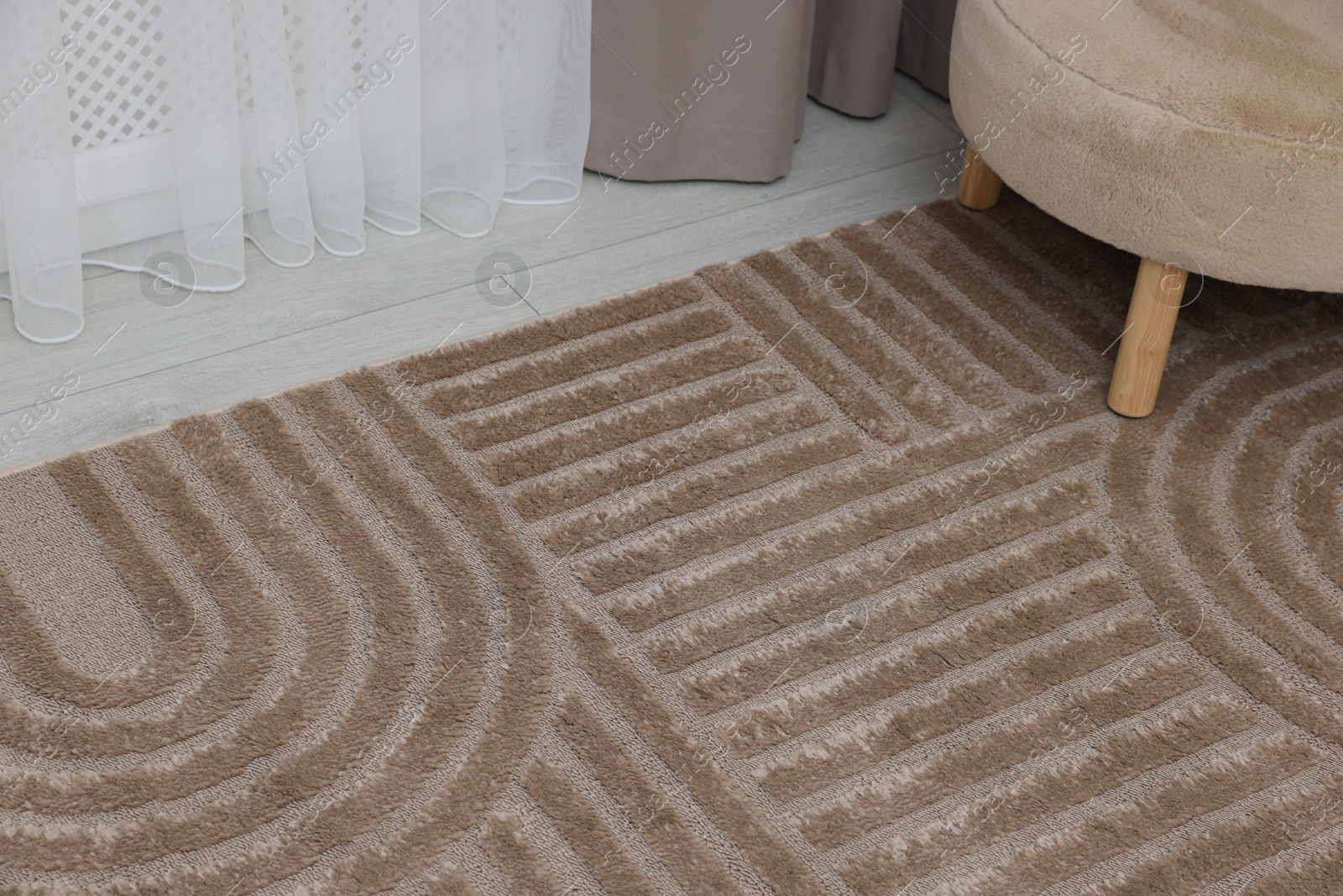 Stylish soft rug with pattern on floor indoors Photo of Stylish soft rug with pattern on floor indoors