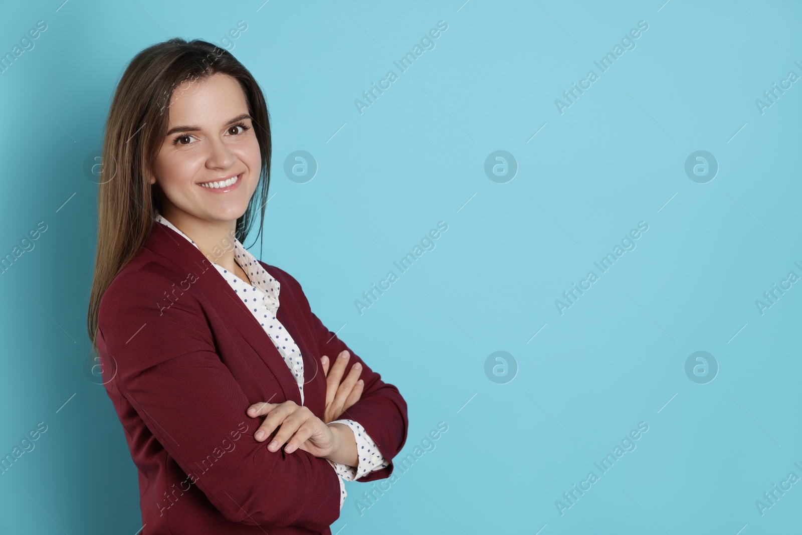 Photo of Banker with crossed arms on light blue background, space for text